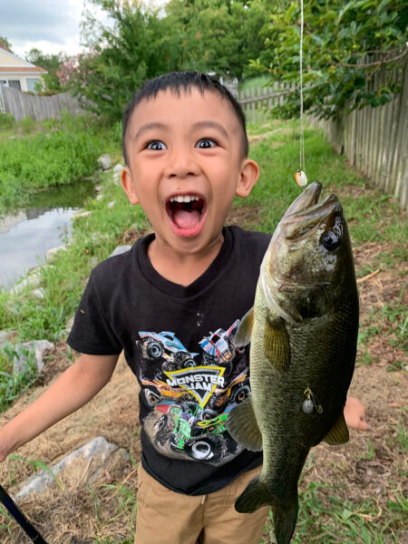 Un niño de 5años, posa emocionado con un pez.